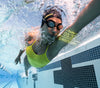 Woman using smart swim goggles while swimming in pool