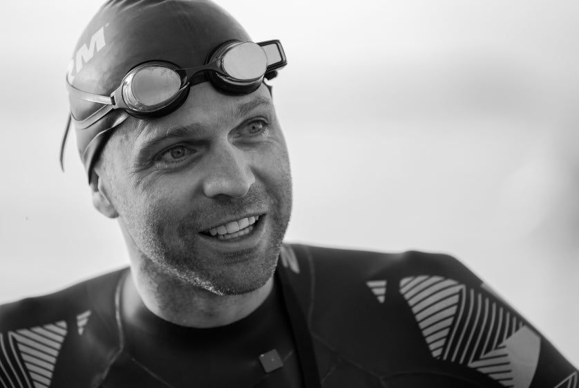 Aaron Royle wearing swim cap, wetsuit, and smart swim goggles