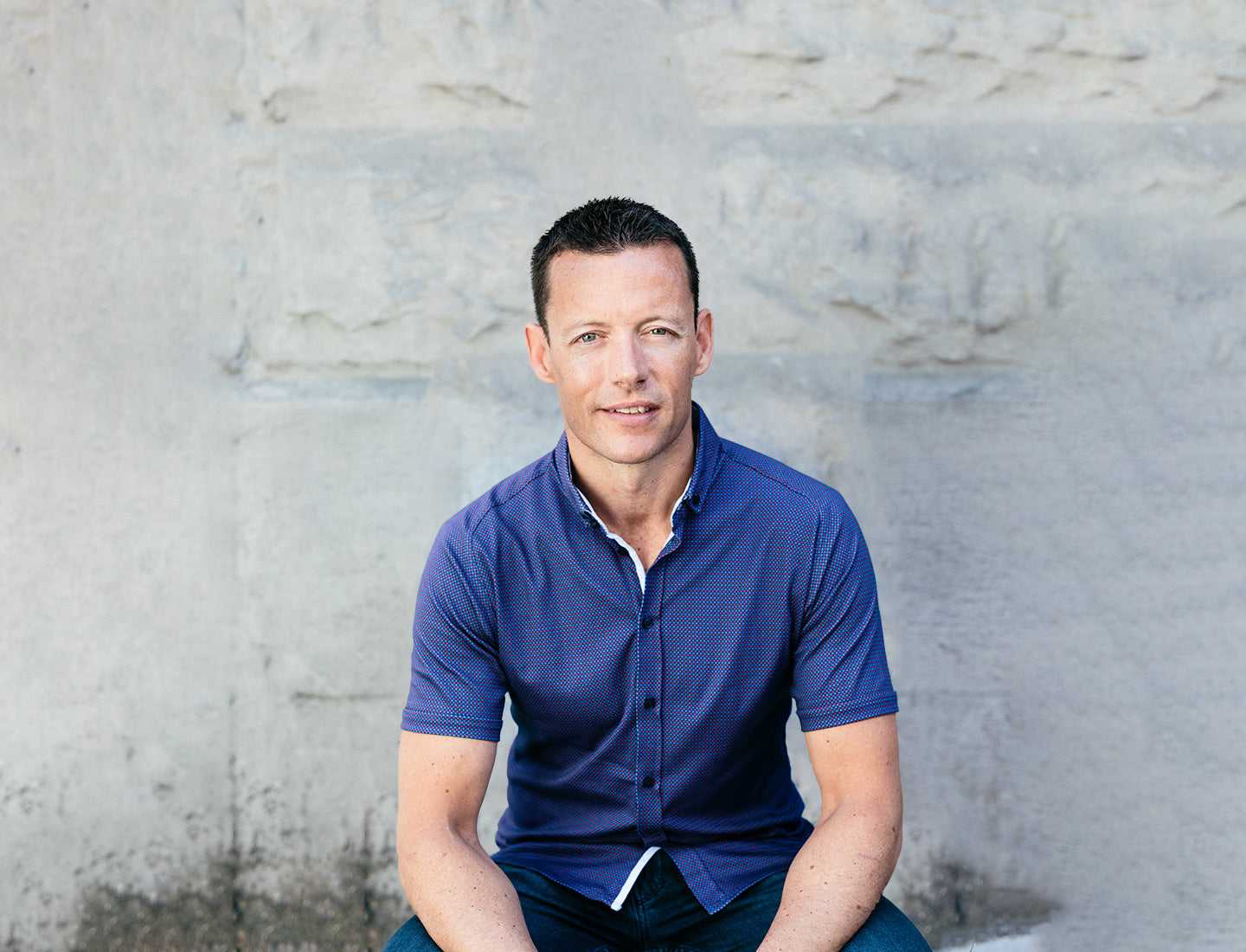 Form CEO Dan Eisenhardt, wearing a blue shirt, sitting against a concrete wall 