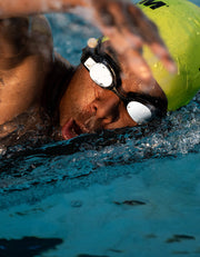 Man swimming front crawl with swim tracker in his goggles